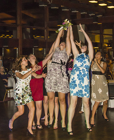 Bridesmaids catching the bridal bouquet